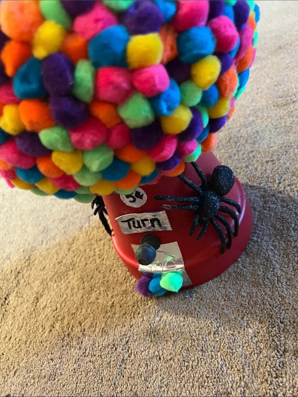 Red Gumball Toy Machine with Multicolor Pom-Pom Cover with Spiders